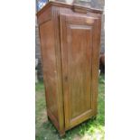 An antique oak hanging cupboard, freestanding and enclosed by a full length rectangular fielded