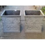 A pair of faux lead (fibreglass) square planters with decorative mask and scrolling foliate