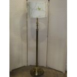 A telescopic cast brass effect standard lamp with reeded column and stepped circular domed base with