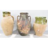 Three partially glazed earthenware vases, the largest 27 cm high.