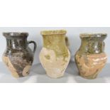 Three partially glazed earthenware jugs.