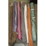 Seven bolts of various fabrics