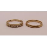 Two 9ct rings; a diamond set half hoop ring, size L and a wedding ring, size K, 3.4g total (2)