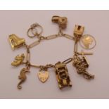 Good quality 9ct bar link charm bracelet hung with eleven novelty charms, to include a motor car,