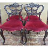 A set of four early Victorian mahogany dining chairs with shaped moulded and pierced backs,