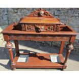 A Victorian gothic carved oak two divisional freestanding umbrella/stickstand with lions mask and
