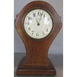 An inlaid Edwardian mantle clock with shaped outline, enamel dial and eight day timepiece