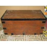 An old stained pine chest with hinged lid and steel banded fittings, drop side carrying handles, 103