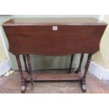 An Edwardian mahogany drop leaf table of narrow proportions, enclosing two frieze drawers with