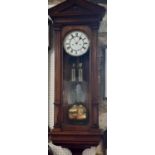 A Lenzkrich Vienna style wall clock, the oak case with reeded column supports and architectural