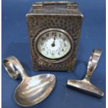 A Goldsmiths & Silversmiths silver hammered finish travelling clock dated 1902, in need of