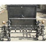 An antique style cast iron fire basket of rectangular form with fleur de-lys finials, (lacks