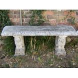 A partially painted and weathered cast composition stone three sectional garden bench, the