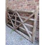 A softwood five bar and X framed chamfered field gate, 280cm wide x 145cm full height (af)