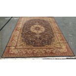 A large Middle Eastern carpet, with a radiating central medallion with an all over floral pattern on