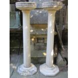 A pair of weathered cast composition stone bird baths/planters of circular form with repeating