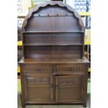A Jaycee reproduction oak cottage dresser, the base enclosed by a pair of twin panelled doors