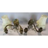 A pair of Regency style double branched wall lights with shell decoration in a gilded finish, and