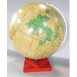 A Philips’ Challenge Globe, mid 20th century, 13 1/2 inch diameter raised on an unusual red