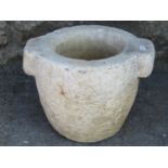 A carved natural stone mortar with pronounced lugs, 31 cm diameter (overall size) x 23 cm high