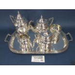 A silver plated five piece tea service on a large silver plated tray, 60cm wide, a cased set of