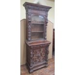 A mid-19th century gothic oak revival pier cabinet, the lower section enclosed by a panelled door