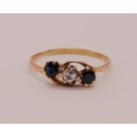 Yellow metal sapphire and diamond crossover ring, size Q, 1.7g