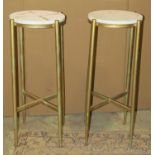 A pair of lamp tables with circular white marble tops raised on gold painted tubular metal