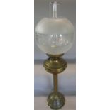 A 19th century brass reeded column oil lamp, with a semi opaque glass shade and chimney, 70cm high