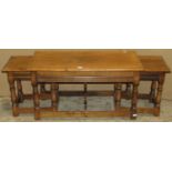 A nest of three good quality occasional tables in the old English style, the outer table of