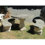 A weathered cast composition stone two sectional garden table with circular radiating floral pattern