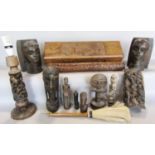 A collection of African carved wood items including a pair of bookends, a table lamp, carved wood