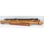 Three wooden tenor and one descant recorders, in a wooden carry case.