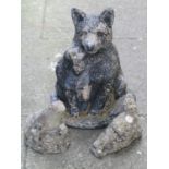 A weathered painted cast composition stone garden ornament in the form of two seated foxes, 44 cm