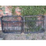 A pair of tubular steel framed driveway entrance gates 236 cm wide x 100 cm high approximately,