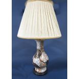 An oriental lamp base of high waisted form with all over blue, burnt orange and gilt floral