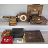 A small collection of biscuit and chocolate tins, OXO tins, and bank’ money box, a clock on wooden