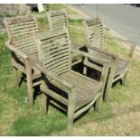 A set of four Cotswold collection weathered teak garden open armchairs with slatted seats and backs