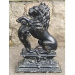 A 19th century cast iron door porter in the form of a rampant lion 38 cm high