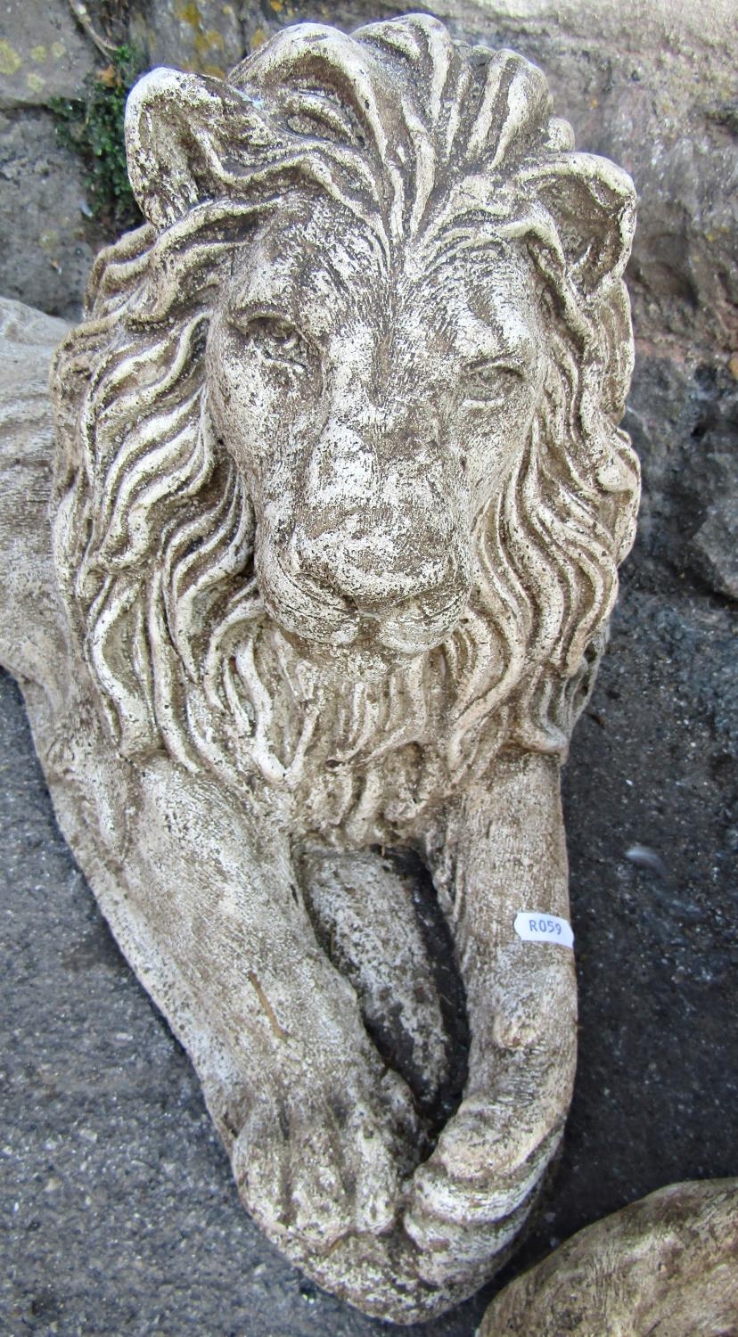 A pair of weathered contemporary cast composition stone recumbent lions, 66 cm wide x 35 cm high - Image 3 of 3