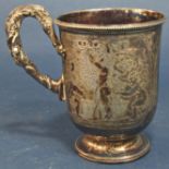 A silver Victorian cup with scrolled handled with engraved Bacchanalian scenes, 11.5cm high, 5.7oz