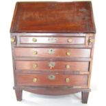 A 19th century apprentice mahogany drop front bureau, with a fitted interior and four drawers,