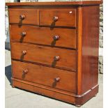 A Victorian mahogany bedroom chest of two short over three long graduated drawers flanked by rounded