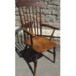 A 19thy century stained elm and beechwood stick back open armchair with saddle shaped seat on turned