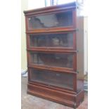 A Globe Wernicke four tier oak bookcase with glazed up and over doors