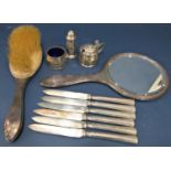 A mixed quantity of silver items to include a hand mirror, a brush set, six silver handled fruit