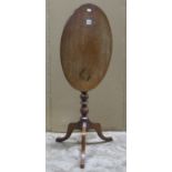 A small 19th century mahogany snap top occasional table raised on a bobbin turned pillar and