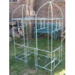 A freestanding light blue painted iron framed vintage bird cage/aviary with twin arched top (for