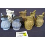 A collection of thirteen 19th century lidded and open relief moulded water jugs to include