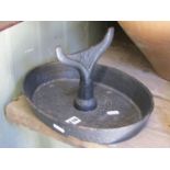 A vintage cast iron boot scraper with oval tray base, 31 cm x 24 cm